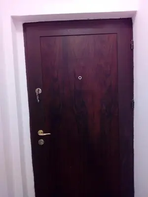 a wooden door in the corner of a room at Apartman Milica in Budva
