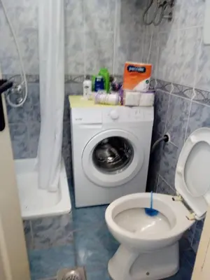 a bathroom with a washing machine and a toilet at Apartman Milica in Budva