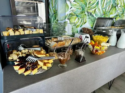 a table topped with lots of different types of food at Hotel Del Medio in Sutomore
