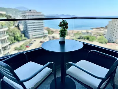 a table and two chairs on a balcony with a view at Hotel Del Medio in Sutomore