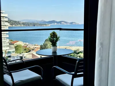 a table and chairs on a balcony with a view of the ocean at Hotel Del Medio in Sutomore