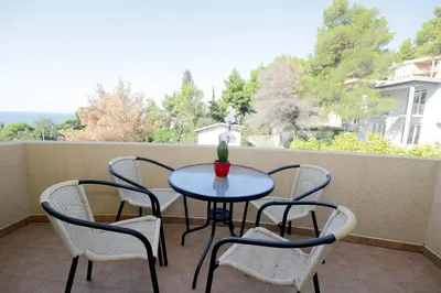 a table and chairs on a balcony with a view at Villa Jupok in Bar
