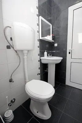 a bathroom with a toilet and a sink at Villa Jupok in Bar