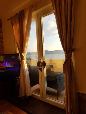 a sliding glass door with a view of the ocean at Villa Jupok in Bar