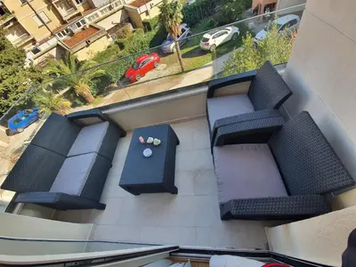 an apartment balcony with chairs and a table on a building at AS Apartments Budva in Budva