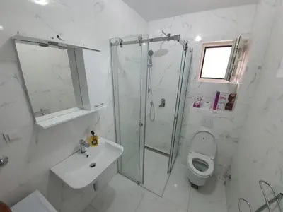 a bathroom with a shower and a toilet and a sink at AS Apartments Budva in Budva