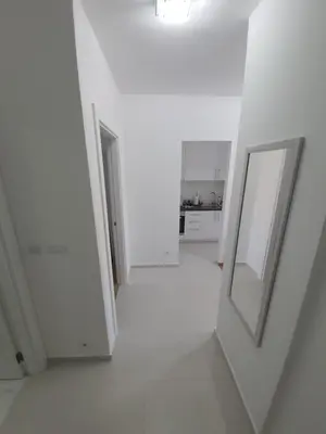 a white room with a mirror on the wall at AS Apartments Budva in Budva