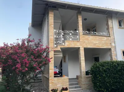 a building with a balcony on the side of it at Vila Jovana in Sutomore
