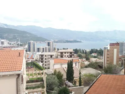 a view of a city with buildings and a body of water at Ksenija apartment in Budva