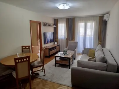 a living room with a couch and a table at Ksenija apartment in Budva