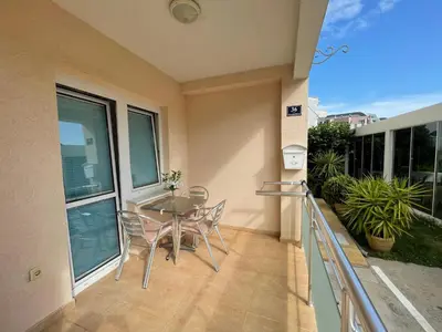 a patio with a table and chairs on a balcony at Villa Kovacevic in Bar