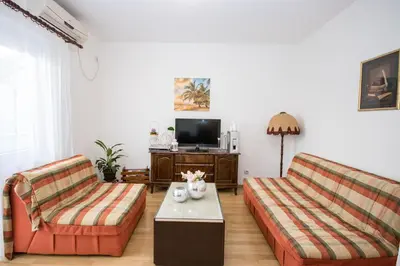a living room with two couches and a tv at Villa Kovacevic in Bar