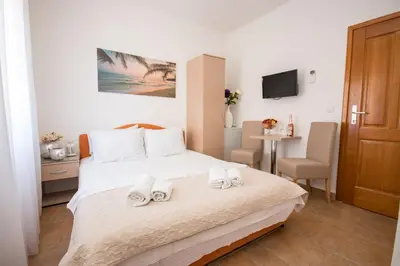 a bedroom with a bed with two towels on it at Villa Kovacevic in Bar