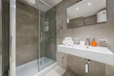 a bathroom with a sink and a shower at Blue Marlin Apartments in Budva