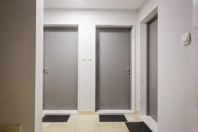two elevator doors in a room with a tile floor at Blue Marlin Apartments in Budva