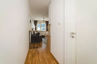 a hallway with white walls and a wooden floor at Blue Marlin Apartments in Budva