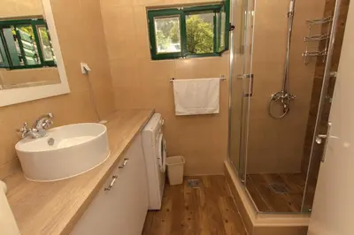 a bathroom with a sink and a shower at Rustic Stone House in Bar