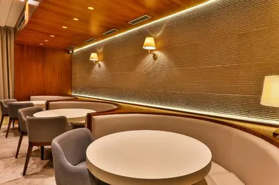 a row of tables and chairs in a waiting room at Apartmani Luka - Vila Brzulovic in Rafailovici