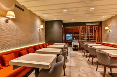 a row of tables and chairs in a restaurant at Apartmani Luka - Vila Brzulovic in Rafailovici