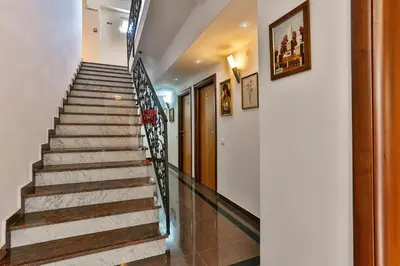 a staircase in a home with white walls and wooden floors at Apartmani Luka - Vila Brzulovic in Rafailovici