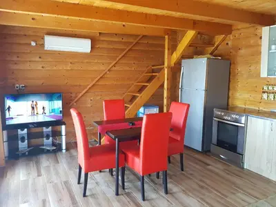 a dining room with a table and red chairs at Summer Holiday House MM in Ulcinj