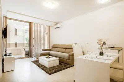 a living room with a couch and a table at Lux Apartment Teodora Rafailovici in Rafailovici