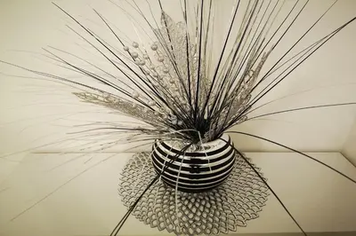 a black and white vase with a plant in it at Lux Apartment Teodora Rafailovici in Rafailovici
