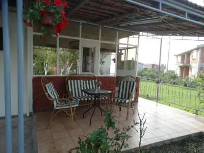 a patio with two chairs and a table on a porch at Apartman Zorana in Bar