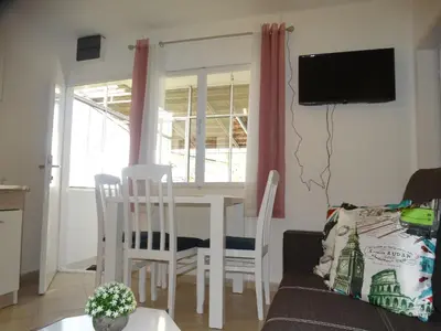 a living room with a table and chairs and a couch at Apartman Zorana in Bar