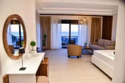 a hotel room with a bed and a mirror at Pino Boutique Hotel in Ulcinj