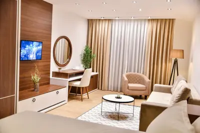 a living room with a couch and a table and a mirror at Pino Boutique Hotel in Ulcinj