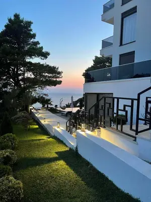 a building with lights on the side of it at Pino Boutique Hotel in Ulcinj