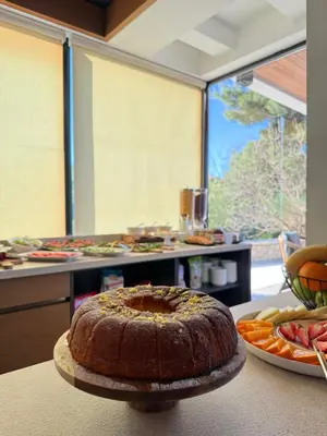a cake sitting on a table in a kitchen at Pino Boutique Hotel in Ulcinj
