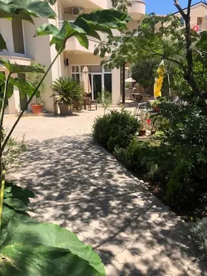 a walkway in front of a house with plants at Residence Bella in Budva