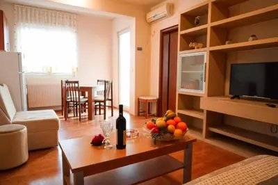 a living room with a table with fruit on it at Residence Bella in Budva