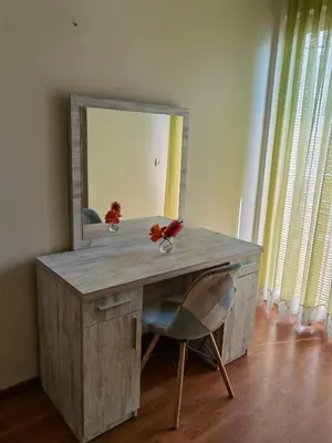 a wooden desk with a mirror and a chair at Residence Bella in Budva
