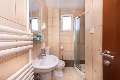 a bathroom with a sink and a toilet and a shower at Residence Bella in Budva
