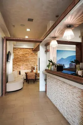 a living room with a white couch and a fireplace at Residence Bella in Budva