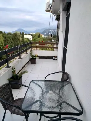 a table and two chairs on a balcony at Apartman Ivona in Bar