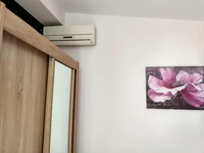 a picture of a pink flower on a wall at Apartman Ivona in Bar