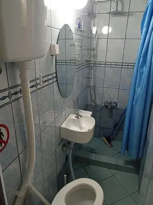 a bathroom with a toilet and a sink and a mirror at Mini Garsonjera in Podgorica