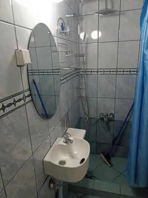 a bathroom with a sink and a mirror at Mini Garsonjera in Podgorica