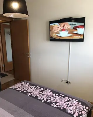 a room with a flat screen tv on the wall at Aphrodite Apartment in Podgorica