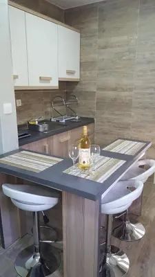 a kitchen with a counter with wine glasses on it at Amarok in Bar