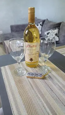 a bottle of wine and two wine glasses on a table at Amarok in Bar