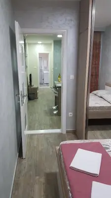 a room with a bed and a desk and a hallway at Amarok in Bar