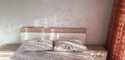 a bed with two pillows on top of it at Amarok in Bar