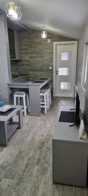 a living room with a kitchen and a table at Amarok in Bar