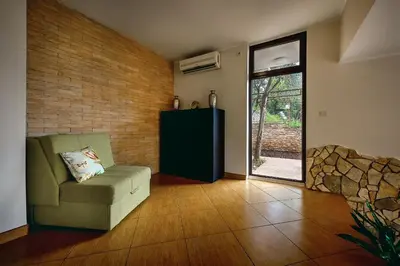 a living room with a couch and a sliding glass door at Villa Milana Budva in Budva