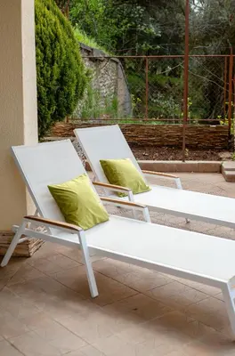 two white chairs with pillows sitting on a patio at Villa Milana Budva in Budva